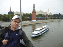 a man wearing a white hat with the letter g on it stands in front of a river