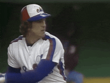 a baseball player wearing a cap with the letter c on it is swinging a bat