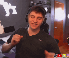 a man wearing headphones and a black shirt with a nike logo