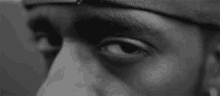 a black and white photo of a person 's eyes looking at the camera .