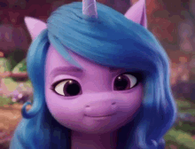 a close up of a purple pony with blue hair and a unicorn horn .
