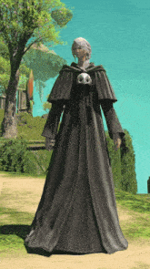 a woman wearing a long black robe with a skull on the front