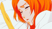 a girl with orange hair is sleeping in a bed