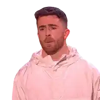 a man with a beard is wearing a white jacket and making a funny face