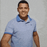 a man wearing a blue calvin klein polo shirt holds up a red lipstick kiss