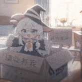 a girl in a witch hat is sitting in a cardboard box