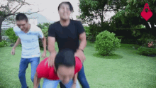 a group of men are playing a game in a park with a red heart in the background .
