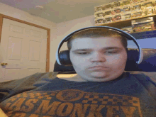 a man wearing headphones is wearing a shirt that says hot wheels