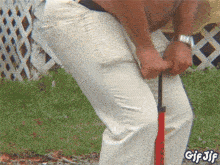 a man is pumping his pants with a red pump