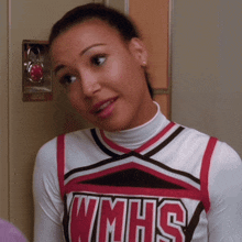a woman wearing a wmhs cheerleader uniform looks at the camera