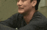 a close up of a man 's face with a blurred background .