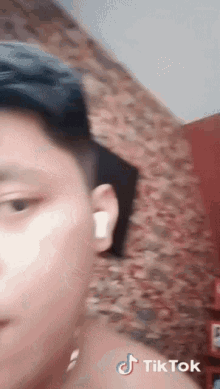 a close up of a man 's face with a tiktok watermark on the bottom