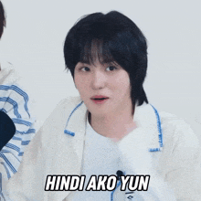 a young man wearing a white jacket with the words hindi ako yun on the front