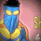 a cartoon character wearing a blue mask and a yellow jacket .