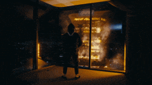 a man stands in front of a burning building with the word ford on the top