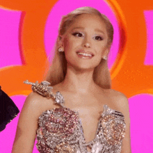a woman is wearing a very sparkly dress and is smiling