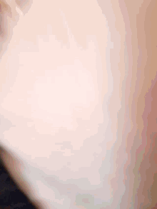 a blurred image of a person 's face with a yellow and red background