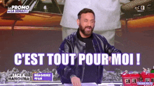 a man in a black leather jacket stands in front of a sign that says c'est tout pour moi