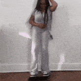 a woman is standing on a skateboard in a room .