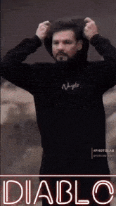 a man is wearing a black hoodie with the word diablo on the bottom