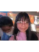 a girl wearing glasses looks at the camera