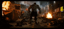the hulk is standing in front of a burning building that says the big buck