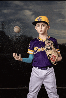 a baseball player wearing a purple jersey that says ' canes '