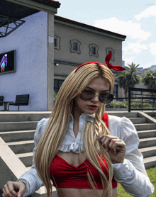 a woman wearing sunglasses and a red headband is standing on stairs