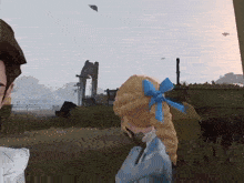 a girl with a blue bow in her hair is standing next to a man in a field .