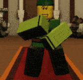 a lego man is standing on a red carpet with his arms outstretched