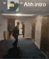 a man in a suit is walking down a hallway with a sign that says `` ahh intro '' .