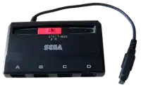 a black sega device with a cord attached