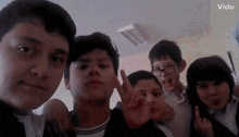 a group of young boys are posing for a picture in a room .