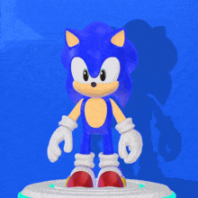 a sonic the hedgehog figurine is standing on a white pedestal