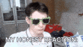 a young man wearing sunglasses and a white shirt says my honest reaction
