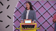 a woman is standing in front of a box that says jess on it
