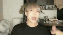 a man in a black shirt with his tongue out