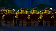 a group of lego figures are standing in front of a house at night