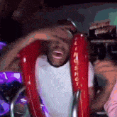 a man is riding a slingshot ride at an amusement park