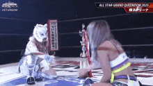 two women are wrestling in a ring and one is wearing a mask .