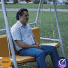 a man sits on a swing with a sign that says $ mcrt game
