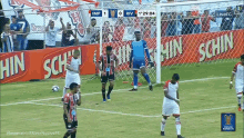 a soccer game is being played in front of a banner that says hin schin