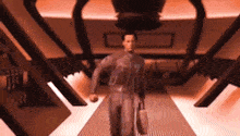 a man walking down a hallway with a briefcase