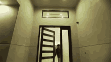a man is standing in front of a door in a house .
