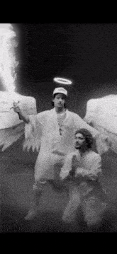 a man dressed as an angel is holding a sword