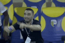 a man wearing a lanyard that says whoahd is dancing
