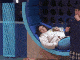 a woman laying on a chair with a sweatshirt that says ' i love you ' on it