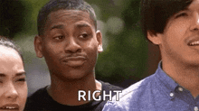 a man is making a funny face and saying `` right '' while standing next to two other men .