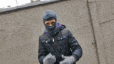 a person wearing a ski mask and a jacket