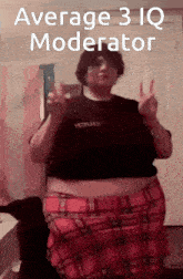 a woman in a plaid skirt is giving the peace sign